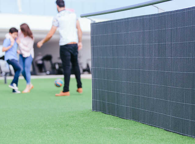 Lop Gray Wicker Look Privacy Screen in the Garden