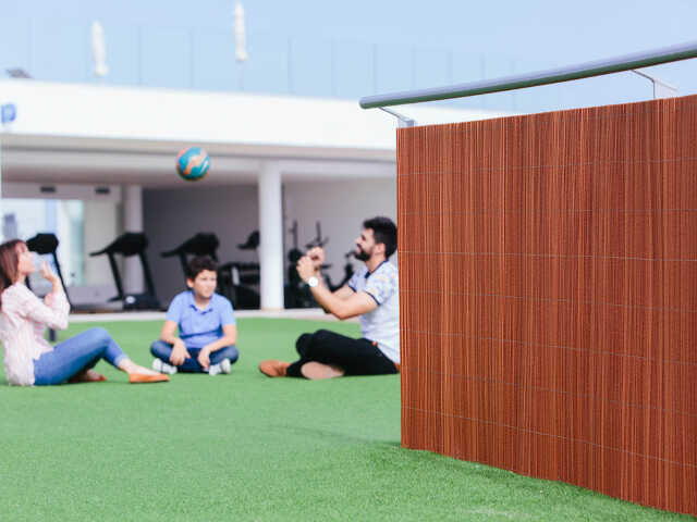 Lop Brown Wicker Look Privacy Screen in the Garden